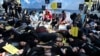Human rights activists stage a protest on a sandy beach to call on EU leaders to do more to protect the rights and lives of migrants, refugees and asylum seekers arriving at Europe's borders, ahead of a European Union leaders summit in Brussels, March 20,