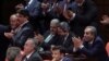 Binali Yildirim, center left, Turkey's current transportation minister, tapped by the ruling party as a candidate for prime minister, applauds with legislators after the vote on a constitutional amendment on parliamentary immunity in Ankara, May 20, 2016. 