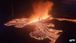 Handout picture released on November 21, 2024 by the Public Defense Department of the State Police Commissioner in Iceland shows lava and smoke erupting from a volcano near Grindavik on the Icelandic peninsula of Reykjanes.