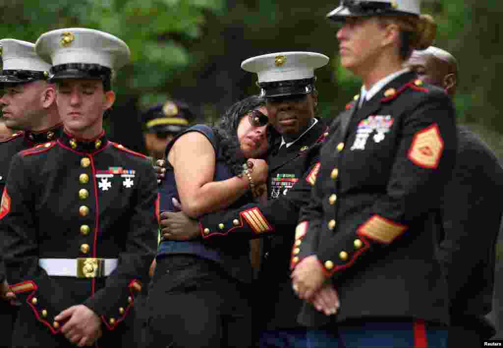 Fellow Marines pay their respects to Marine Corps Sgt. Johanny Rosario Pichardo, who was among 13 U.S. service members killed in the airport suicide bombing in Afghanistan&#39;s capital Kabul, in her hometown in Lawrence, Massachusetts, Sept. 14, 2021.