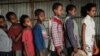 FILE - Children, who fled the violence in Ethiopia's Tigray region, wait in line for breakfast organized by a self-volunteer, in Mekelle, the capital of Tigray region, June 23, 2021. 