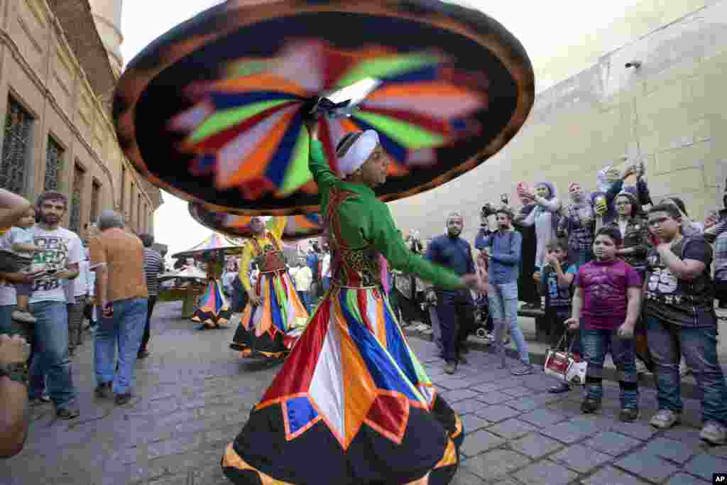Whirling dervishes participate in The International Festival for Drums and Traditional Arts in El-Moez street in historical Fatimid Cairo, Egypt. The festival hosts teams from around 23 countries raising the slogan "Drums Dialogue for Peace" aiming to spread tolerance and cultural awareness.