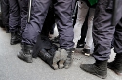 FILE - Police detain a gay rights activist during a rally marking May Day in downtown St. Petersburg, Russia, May 1, 2017.