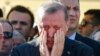Turkish President Recep Tayyip Erdogan wipes tears during the funeral of Mustafa Cambaz, Erol and Abdullah Olcak, killed Friday while protesting the attempted coup against Turkey's government, in Istanbul, July 17, 2016. 