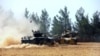 FILE - A Turkish army tank and an armored vehicle are stationed near the border with Syria, in Karkamis, Turkey, Aug. 23, 2016. Turkey now has its eyes on the Syrian city on Manbij it sees as critically important in its fight against Kurdish rebels.