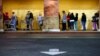 Shoppers wait outside a Kmart store for it to open on Thursday, Nov. 28, 2013, in Anaheim, California.