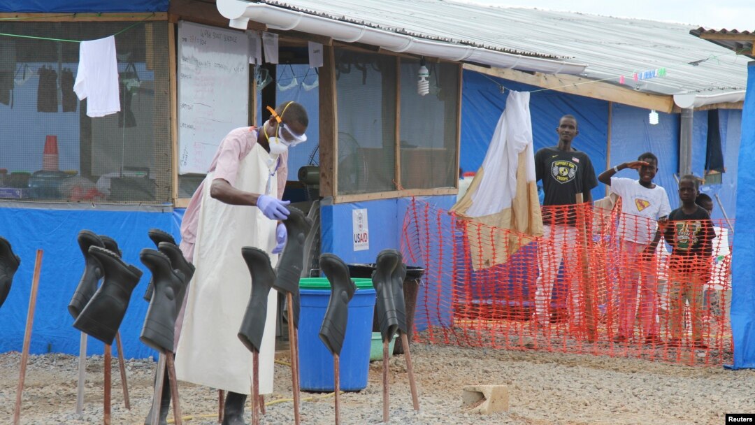 Boys stand in the "red zone" where they are being treated for Ebola at the Bong County Ebola treatment unit about 160 miles east of Monrovia, Liberia, in this Oct. 28, 2014, file photo. 