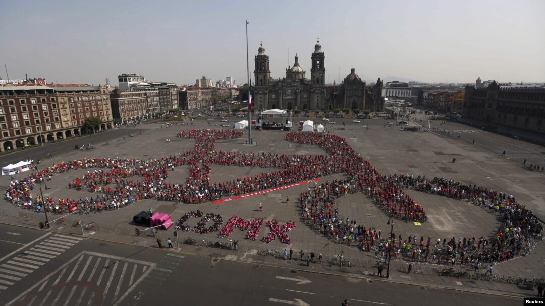 FILE - Cyclists gather to form a shape of a bicycle with the aim of promoting cycling as a mode of transport and to commemorate Bicycle Day, which is celebrated April 19 annually, at Zocalo square in Mexico City, Mexico, April 10, 2016. 