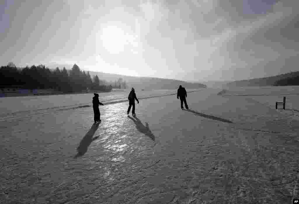 People enjoy skating on a maintained icy track on the vast frozen surface of the Lipno dam near the village of Frymburk, Czech Republic. This year's unusually cold winter has turned the country's largest lake into a skating heaven.