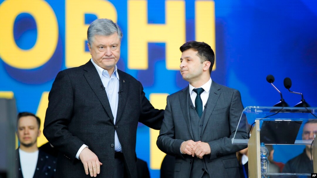 Ukrainian President Petro Poroshenko, left, and Ukrainian presidential candidate and popular comedian Volodymyr Zelenskiy attend debates at the Olympic stadium in Kyiv, Ukraine, April 19, 2019. 