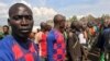 FILE - Congolese Mai-Mai rebels who surrendered their weapons to government officials stand in a formation in Kitchanga, in the Masisi territory of North Kivu province, in the Democratic Republic of Congo, June 21, 2021. 