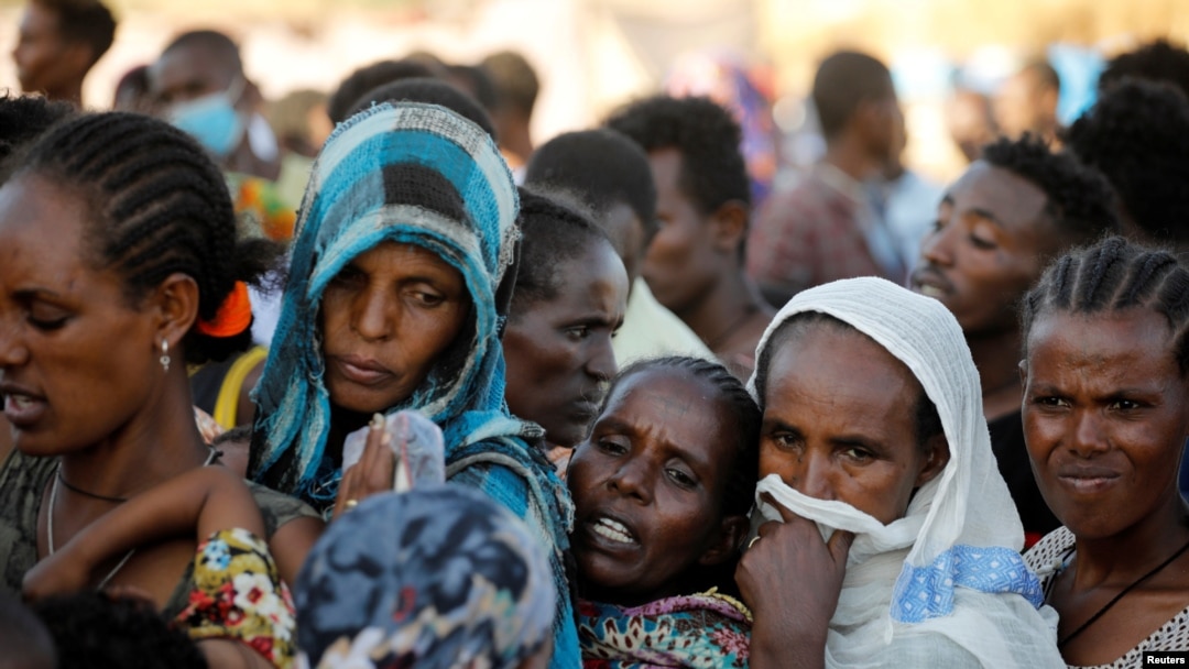 FILE - Ethiopian refugees line up for supplies at the Um Rakouba refugee camp, which houses refugees fleeing the fighting in the Tigray region, on the Sudan-Ethiopia border in Sudan, Nov. 29, 2020. 