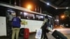 FILE - A migrant domestic worker from Africa pulls her luggage toward a bus that will take her with others to the airport to travel back to their home countries, in a Beirut suburb, Lebanon, Oct. 5, 2020.