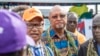 Bougainville regional president John Momis, left, speaks to the media before casting his ballot in an historical independence vote as the Papua New Guinea minister for Bougainville affairs, Puka Temu, center, looks on in Buka on Nov. 23, 2019. 