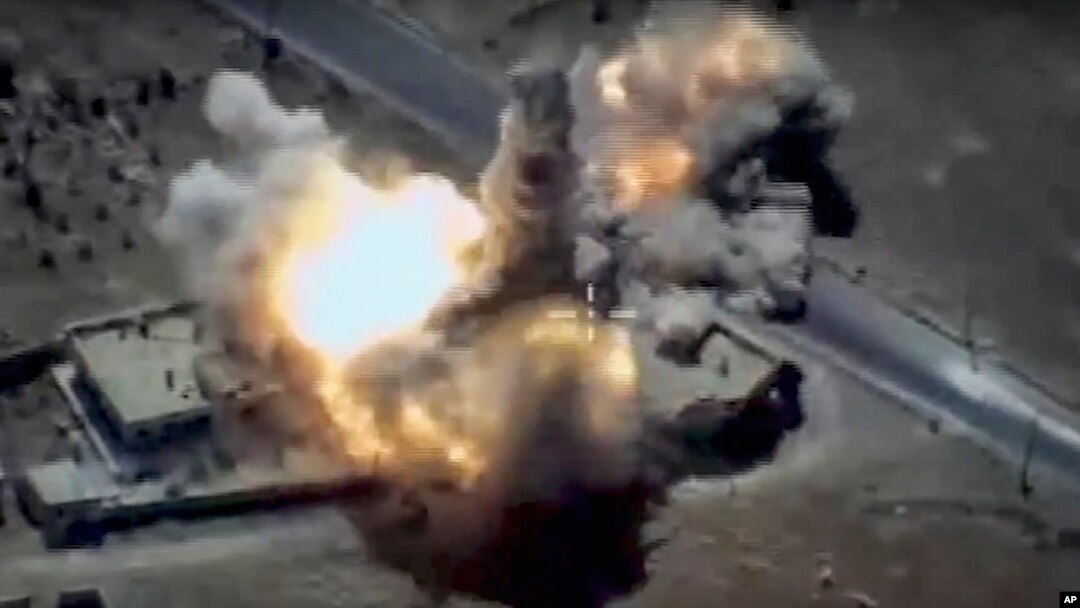 FILE - This image provided by Russian Defense Ministry Press Service and released June 23, 2017, shows a target in Syria hit by a missile launched by a Russian navy ship in the eastern Mediterranean. Russia's Defense Ministry said it fired cruise missiles from the Mediterranean Sea on positions of the Islamic State in Syria.