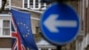 FILE - An EU flag hangs beside the Union flag at Europa House in London, Feb. 17, 2016. EU officials warn that a Brexit would force London to renegotiate free trade deals with EU member states. 
