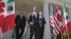 U.S. President Barack Obama, (C), Canada's Prime Minister Stephen Harper (R), and Mexico's President Felipe Calderon (L) walk out of the Oval Office before a joint press conference in the Rose Garden of the White House in Washington, April 2, 2012.