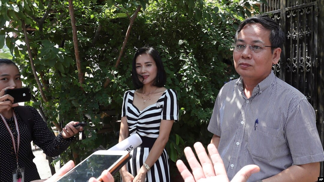 Pheng Heng, right, lawyer to former Cambodia National Rescue Party's President Kem Sokha, speaks to media in front of Kem Sokha's house in Phnom Penh, Cambodia, Nov. 10, 2019.