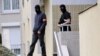 Policemen leave an appartment building, where investigators searched a lock-up garage possibly used by people arrested during an anti-terror operation conducted four days ago, October 10, 2012 in Torcy, east of Paris.