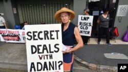 FILE - Anti-Adani coal mine protestor Rae Sheridan is seen outside the LNP (Liberal National Party) headquarters in Brisbane, April 11, 2019. The protestors are trying to stop the building of Adani's Carmichael coal mine. 