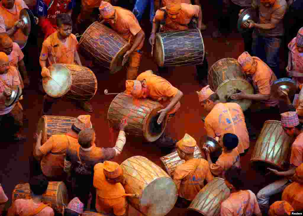 Devotees play traditional musical instruments while celebrating the "Sindoor Jatra" vermillion powder festival at Thimi, in Bhaktapur, Nepal, April 15, 2017.