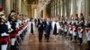 French president Francois Hollande, center, flanked by his companion Valerie Trierweiler, right, Paris' mayor Bertrand Delanoe, second left,and Paris' deputy mayor Anne Hidalgo arrives to deliver a speech as part of a ceremony held at Paris' town hall, Pa