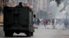 FIILE - Egyptian security forces clash with supporters of ousted president Mohamed Morsi at Nasr City district in Cairo, Nov. 22, 2013. Ties between Turkey and Egypt were severed following Morsi's removal, but relations between the two countries are warming up again.