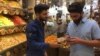 Saman Sadq, left, in his family's sweets and nuts shop, says that for him, Kurdish independence is a natural right, in Erbil, Kurdish Iraq, Sept. 5, 2017. 