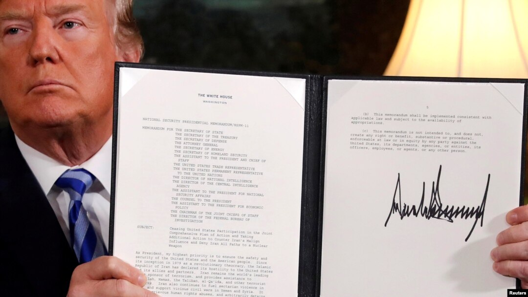 FILE - U.S. President Donald Trump holds up a proclamation declaring his intention to withdraw from the JCPOA Iran nuclear agreement after signing it in the Diplomatic Room at the White House in Washington, May 8, 2018.