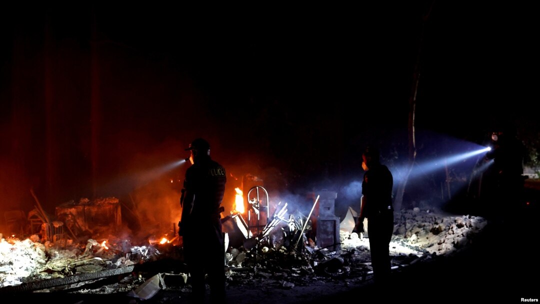 Firefighters make a stand in the backyard of a home in front of the advancing CZU August Lightning Complex Fire on Aug. 21, 2020, in Boulder Creek, Calif. 