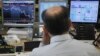 A trader looks at his screens during a bond auction on a trading floor in Madrid, June 7, 2012. 