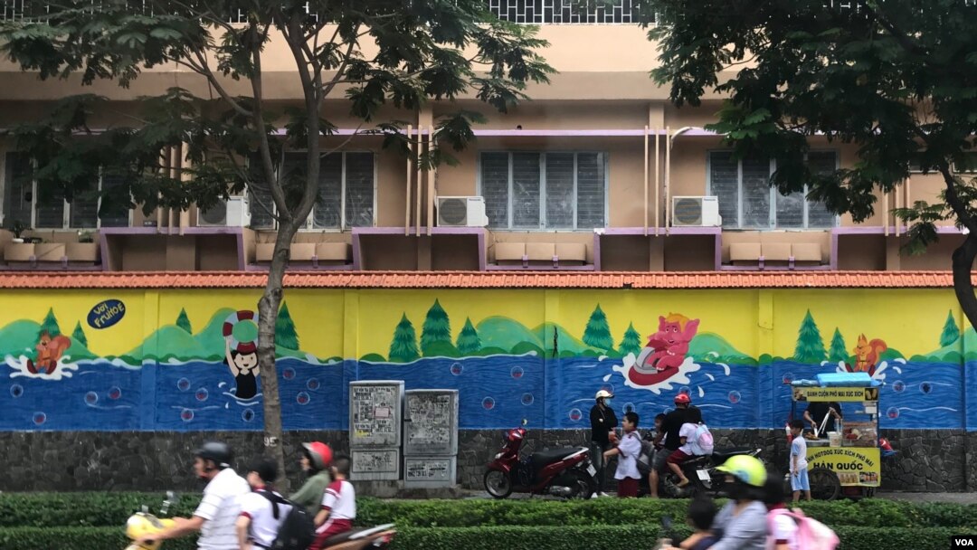 FILE - Children get picked up to go home after school in Ho Chi Minh City, Vietnam.