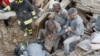 Rescuers work in the night at a collapsed house following an earthquake in Pescara del Tronto, central Italy, August 24, 2016. 