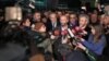 Can Dundar, the editor-in-chief of opposition newspaper Cumhuriyet, center right, and Erdem Gul, the paper's Ankara representative, center left, speak to the media outside Silivri prison near Istanbul, after their release early Friday, Feb. 26, 2016.