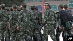 Armed police officers patrol an ethnic Uighur area in Kashgar, in Xinjiang province Aug. 4, 2011.