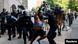 FILE - Police clear protesters from Lafayette Park and the area around it across from the White House for President Donald Trump to be able to walk to St. John's Church on June 1, 2020.