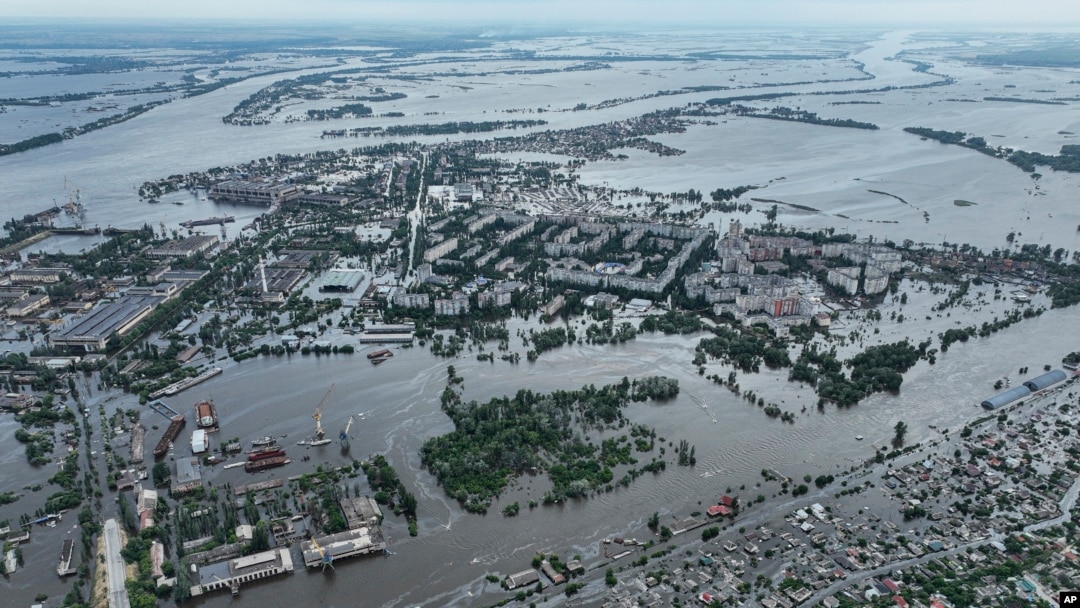 Houses are seen underwater and polluted by oil in a flooded neighbourhood in Kherson, Ukraine, Saturday, June 10, 2023. (AP Photo)