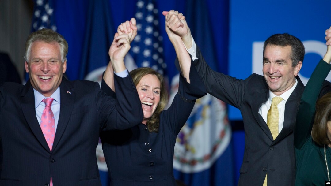 Virginia's governor-elect, Ralph Northam, right, celebrates his election win with Virginia Governor Terry McAuliffe and his wife, Dorothy, in Fairfax, Virginia. Nov. 7, 2017.