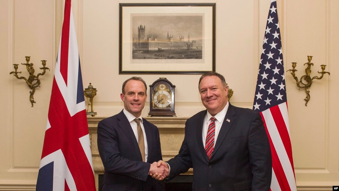 FILE - UK Foreign Secretary Dominic Raab shakes hands with US Secretary of State Mike Pompeo in London, Jan. 29, 2020. 
