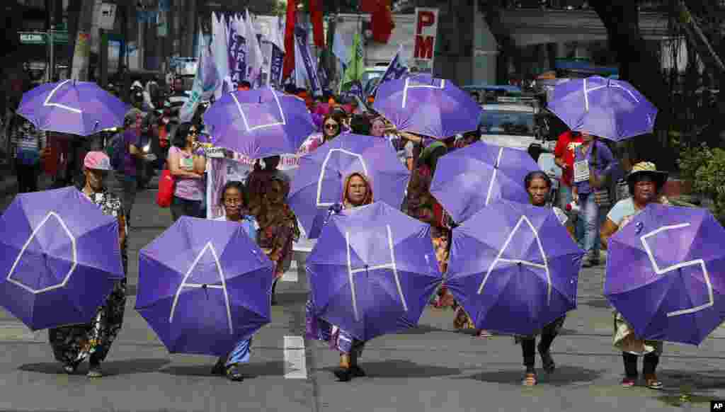 Women march during a rally marking International Women's Day, in Manila, the Philippines.