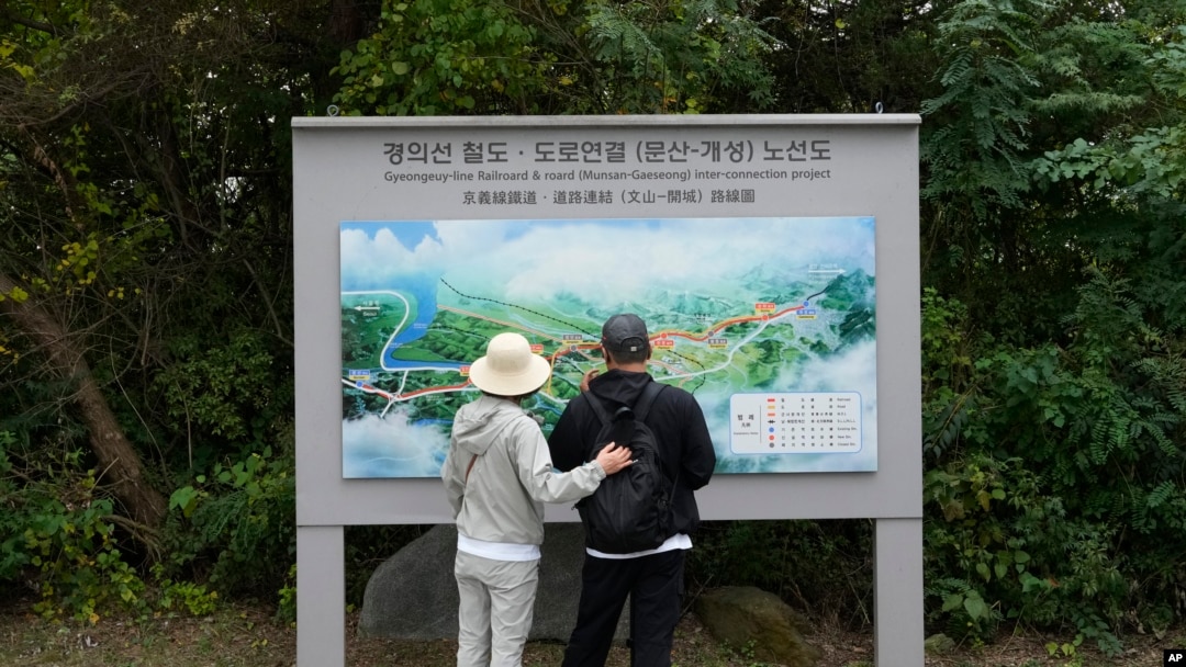 South Korean visitors look at a map which shows a border area of two Koreas with a railroad line between Munsan city in south and Kaesong in north, at the Imjingak Pavilion in Paju, South Korea, near the border with North Korea, Oct. 14, 2024.