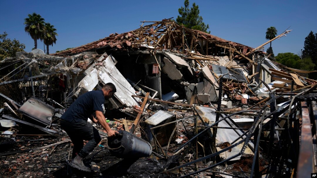 A man works next to a destroyed home after rockets struck in Katzrin, in the Israeli-annexed Golan Heights, on Aug. 21, 2024. Lebanon's Hezbollah launched more than 50 rockets, hitting a number of private homes in the area.