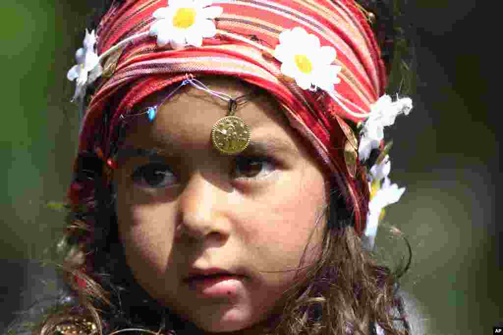 A Roma girl poses for photographers during celebrations for the &#39;Hidirellez&#39; festival in Edirne, Turkey, near the Greek and Bulgarian borders. . The &#39;Hidirellez&#39; festival attracts thousands to the celebration, marking the return of spring, with dancing, bonfires and bathing in the Tundzha River.