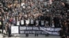Hundreds of Turkish journalists, some holding photos of recently jailed journalists, march to protest the detention of journalists in an alleged coup plot and demand reforms to Turkey's media laws, in Ankara, Turkey, Mar. 19, 2011.