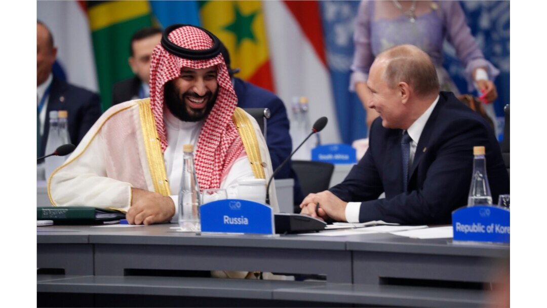 FILE - Saudi Arabia's Crown Prince Mohammed bin Salman talks with Russian President Vladimir Putin during a G-20 session with other heads of state, in Buenos Aires, Argentina, Nov. 30, 2018.