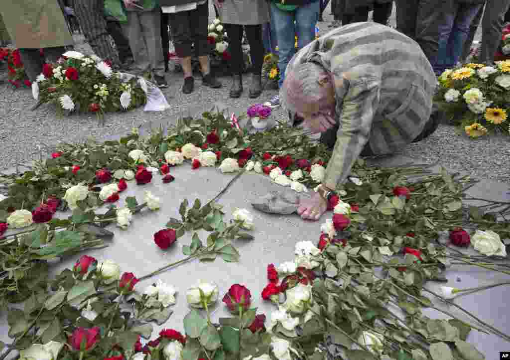 Nazi concentration camp survivor Alexander Bytschok of Kyiv, Ukraine, mourns on a metal plaque during the commemoration ceremonies for the 72th anniversary of the liberation of the former Nazi concentration camp Buchenwald near Weimar, Germany.