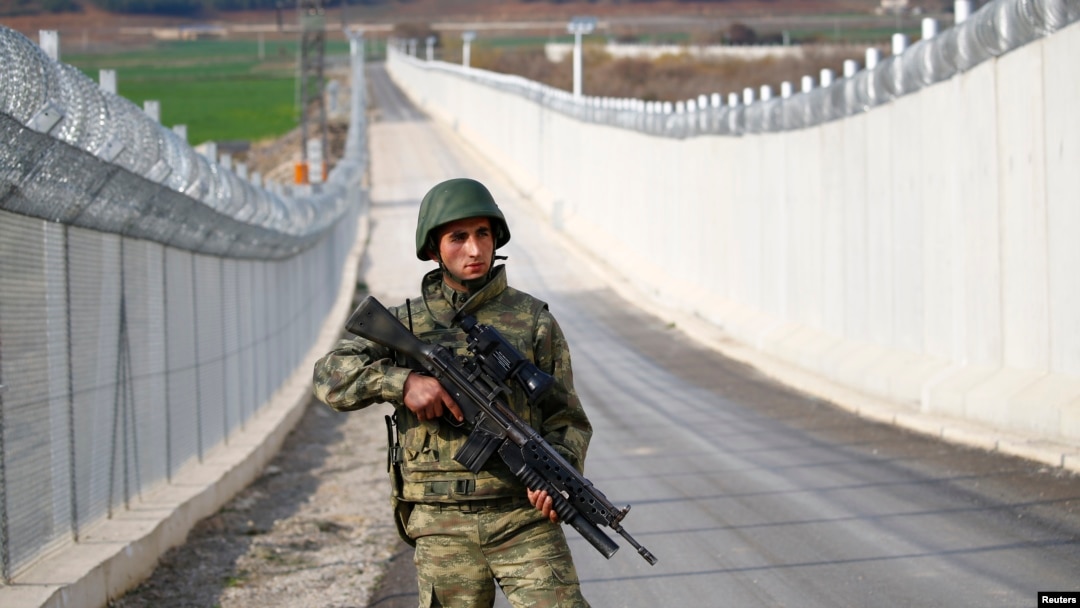 FILE - A Turkish soldier patrols along a wall on the border line between Turkey and Syria near the southeastern city of Kilis, Turkey, March 2, 2017.