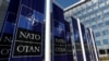 FILE PHOTO: Banners displaying the NATO logo are placed at the entrance of new NATO headquarters during the move to the new building