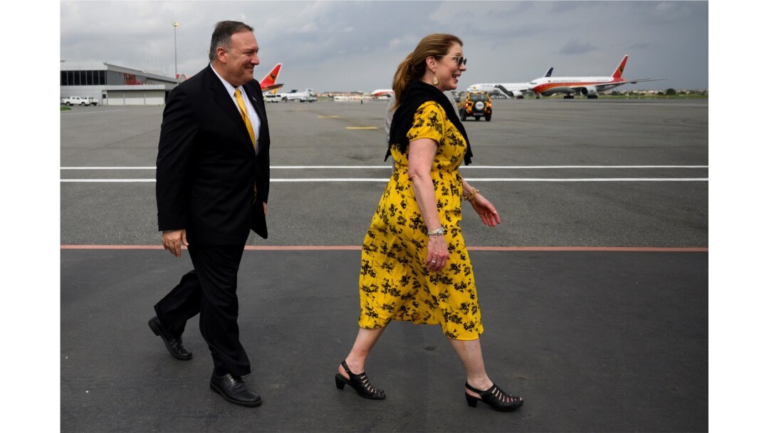 U.S. Secretary of State Mike Pompeo and his wife Susan Pompeo walk on the tarmac before departure at Luanda International Airport in Luanda, Angola, Feb. 17, 2020.