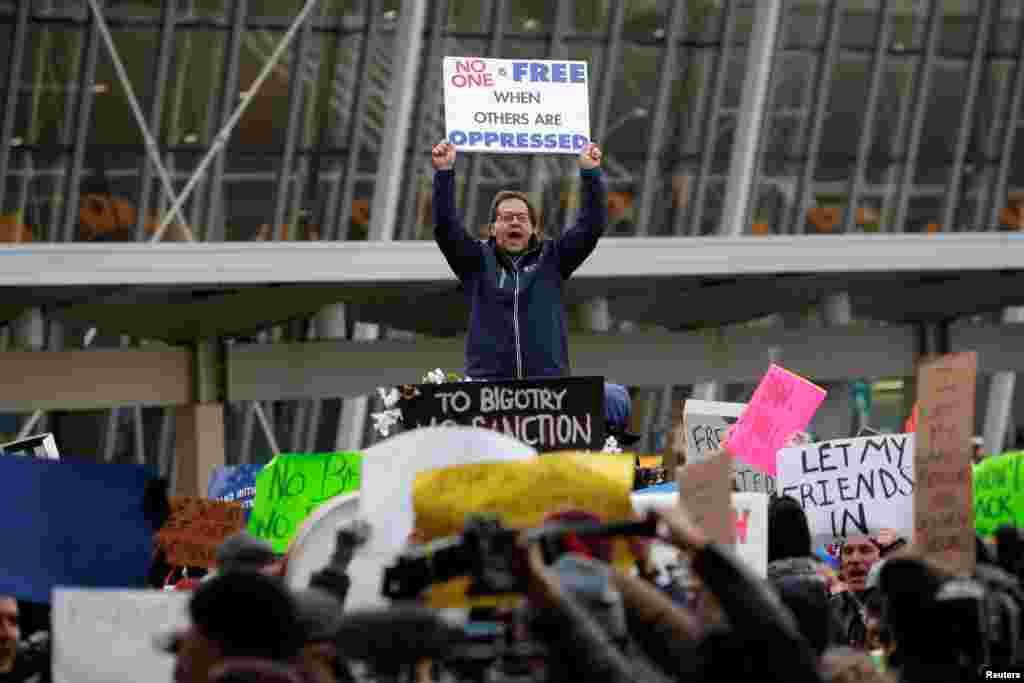 A man yells during a protest against U.S. President Donald Trump's travel ban, outside Terminal 4 at John F. Kennedy International Airport in Queens, New York, Jan. 28, 2017.